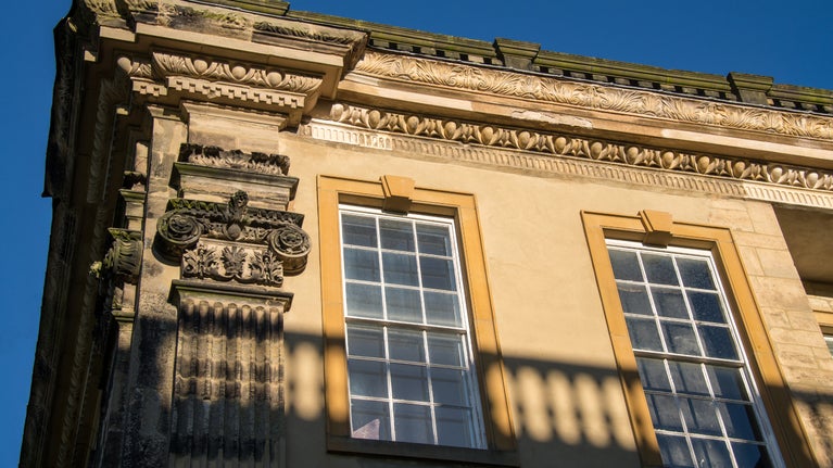 Image shows a close up of the third floor windows of the house